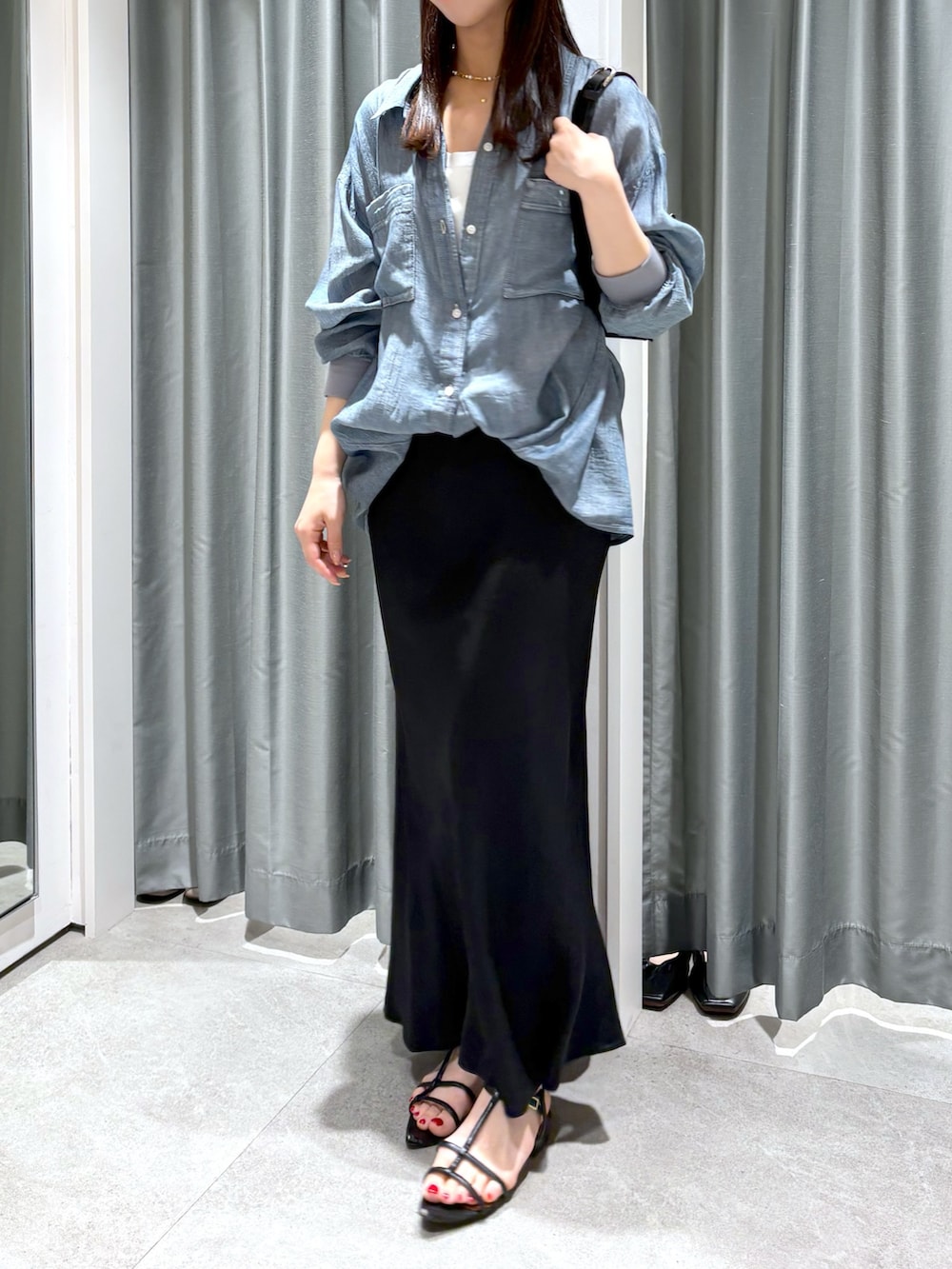 ブラック系のスカート、ブルー系のシャツ/ブラウス、ホワイト系のTシャツ/カットソーを着用したレディースの夏コーディネートの2枚目の写真