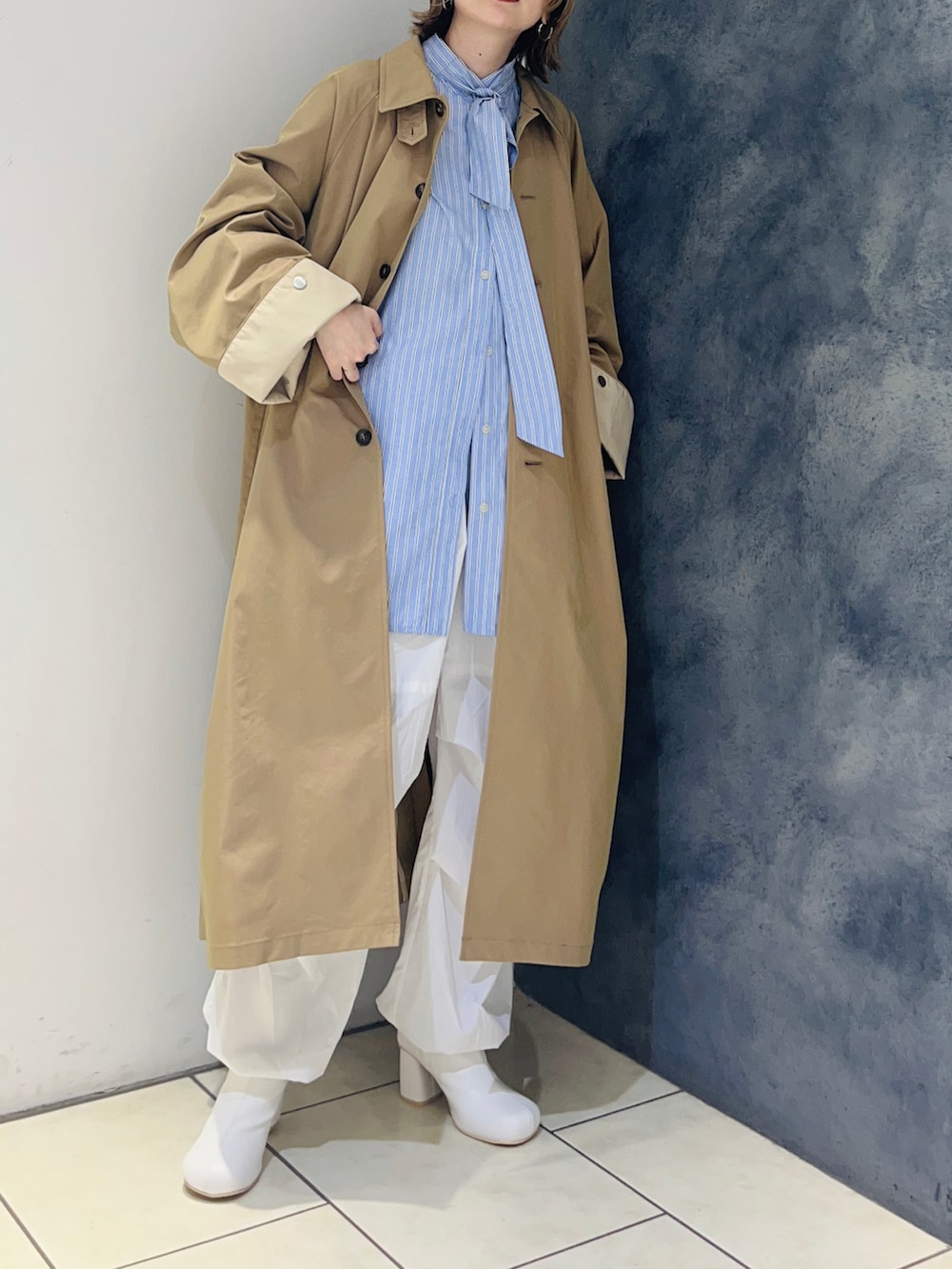 ブルー系のシャツ/ブラウス、ベージュ系のステンカラーコート、ホワイト系のその他パンツを着用したレディースの冬コーディネートの4枚目の写真