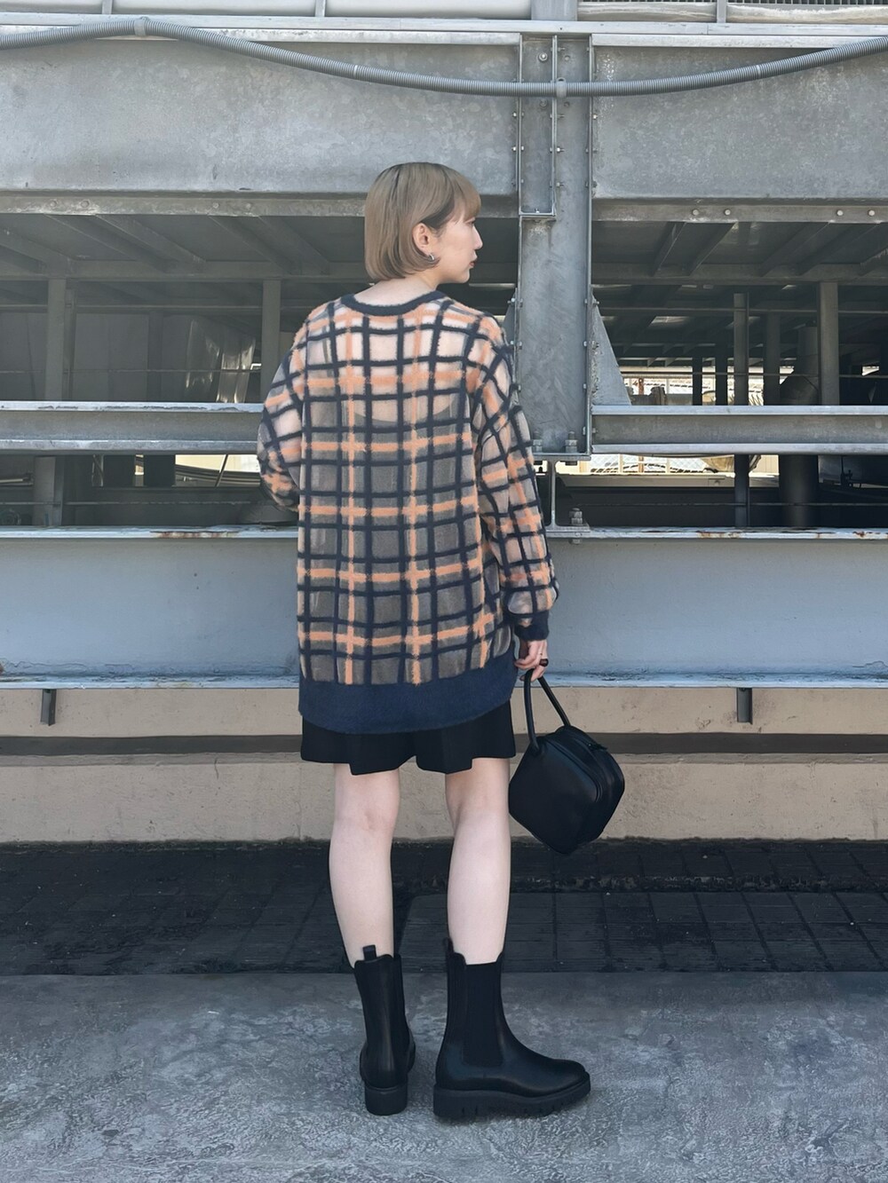 ブルー系のニット/セーター、ブラック系のその他パンツ、ブラック系のハンドバッグを着用したレディースの秋コーディネートの3枚目の写真