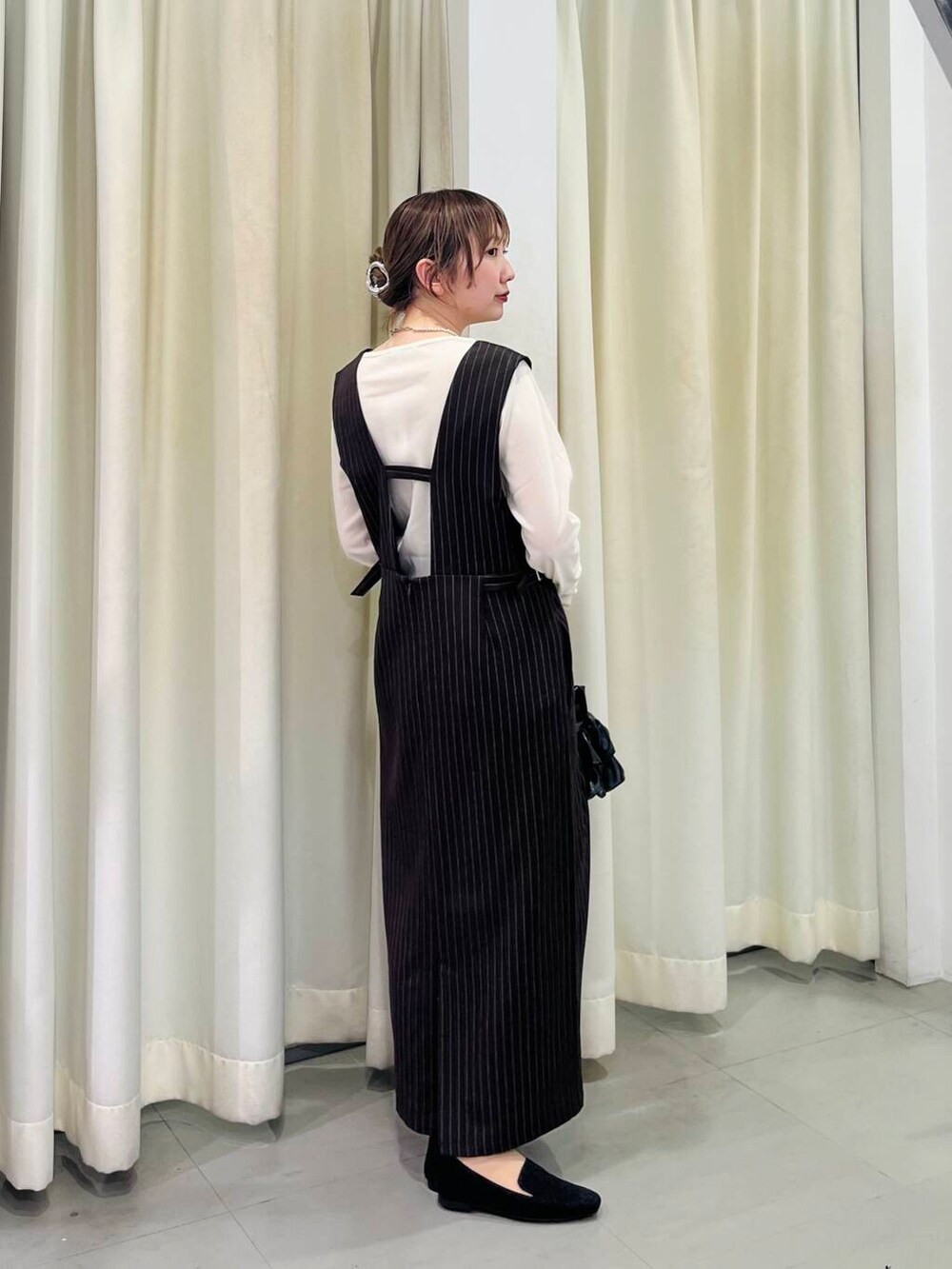 ブラック系のローファー、ブラック系のハンドバッグ、ホワイト系のTシャツ/カットソーを着用したレディースの春コーディネートの3枚目の写真