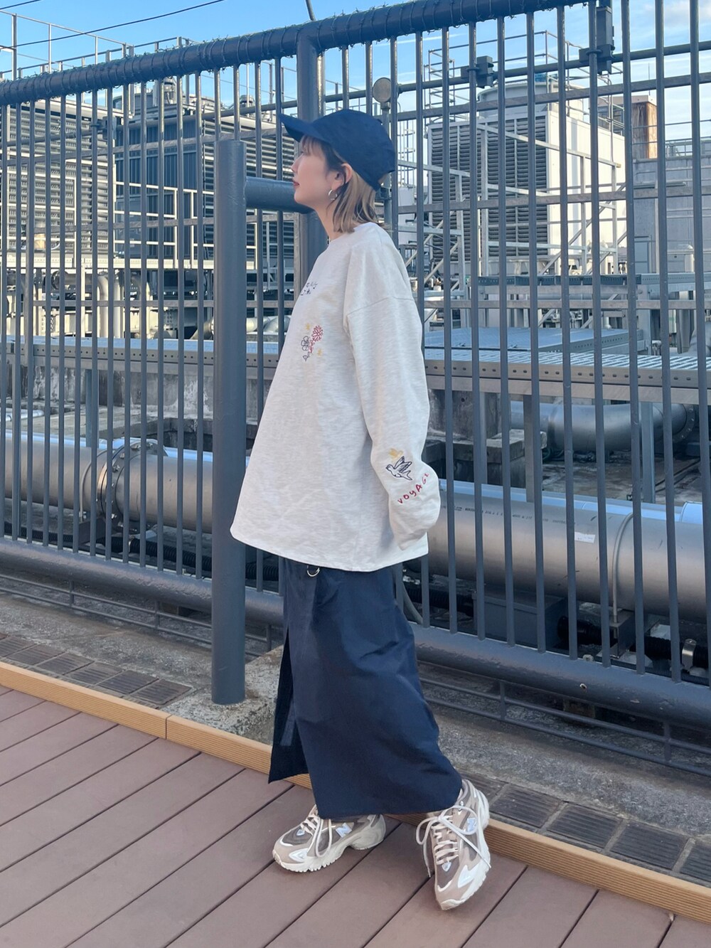 グレー系のTシャツ/カットソー、ホワイト系のスカートを着用したレディースの春コーディネートの4枚目の写真