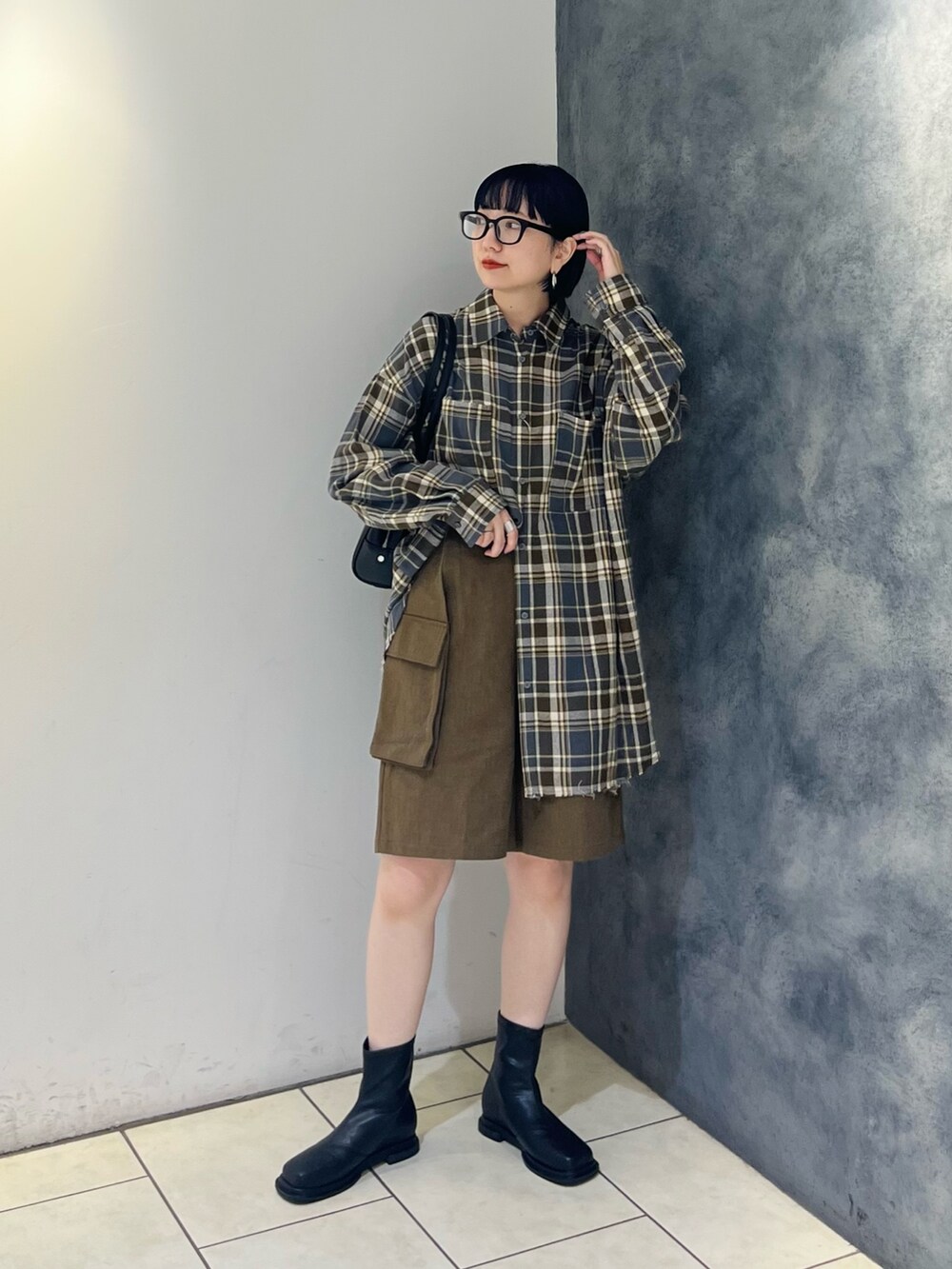 グレー系のシャツ/ブラウス、グリーン系のその他パンツ、ブラック系のブーツを着用したレディースの秋コーディネートの2枚目の写真