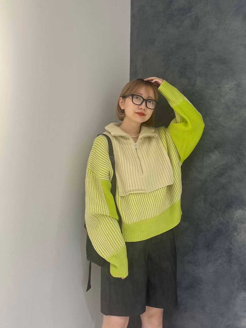 グリーン系のニット/セーター、グレー系のその他パンツ、ブラック系のショルダーバッグを着用したレディースの秋コーディネートの5枚目の写真