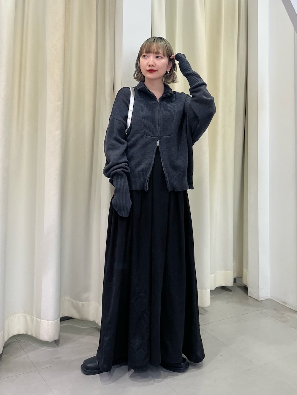 シルバー系のショルダーバッグ、ブラック系のワンピースを着用したレディースの秋コーディネートの4枚目の写真