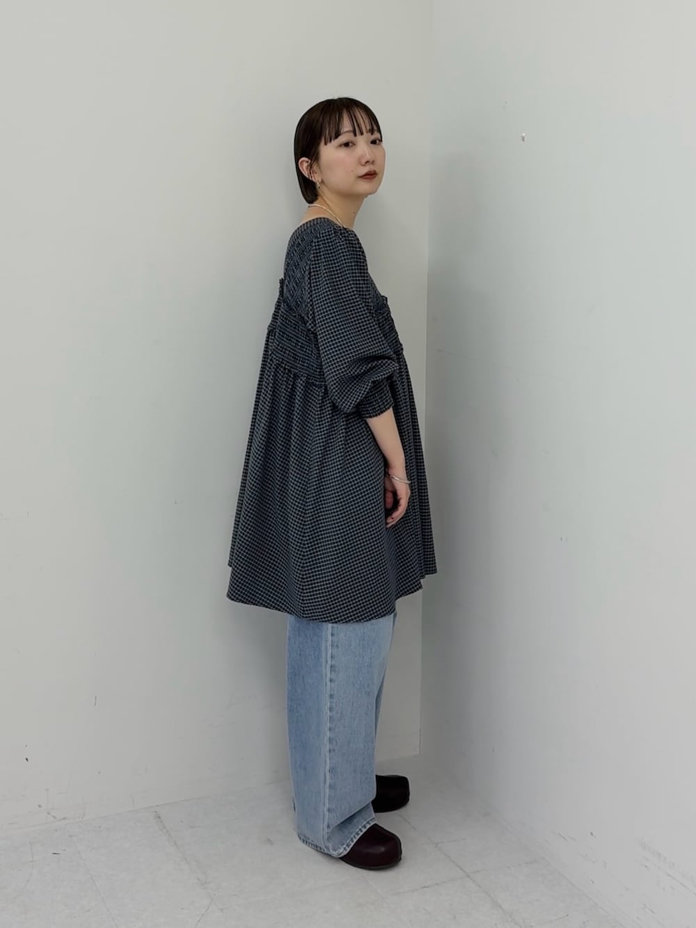 ブルー系のデニムパンツ、ブルー系のワンピースを着用したレディースの冬コーディネートの2枚目の写真