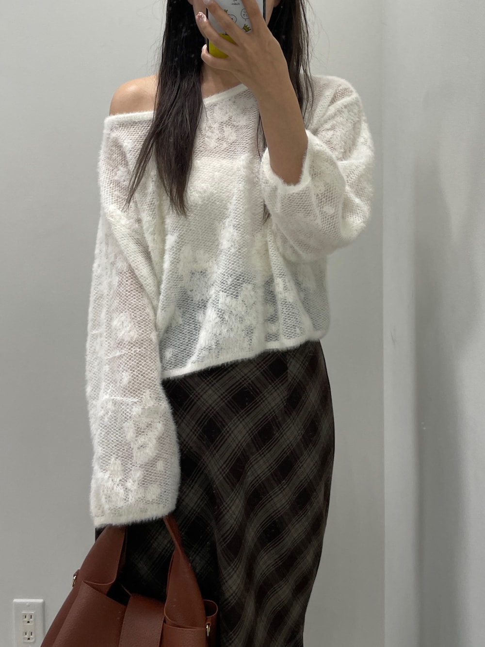 ホワイト系のニット/セーター、ブラウン系のスカート、ブラウン系のハンドバッグを着用したレディースの秋コーディネートの3枚目の写真