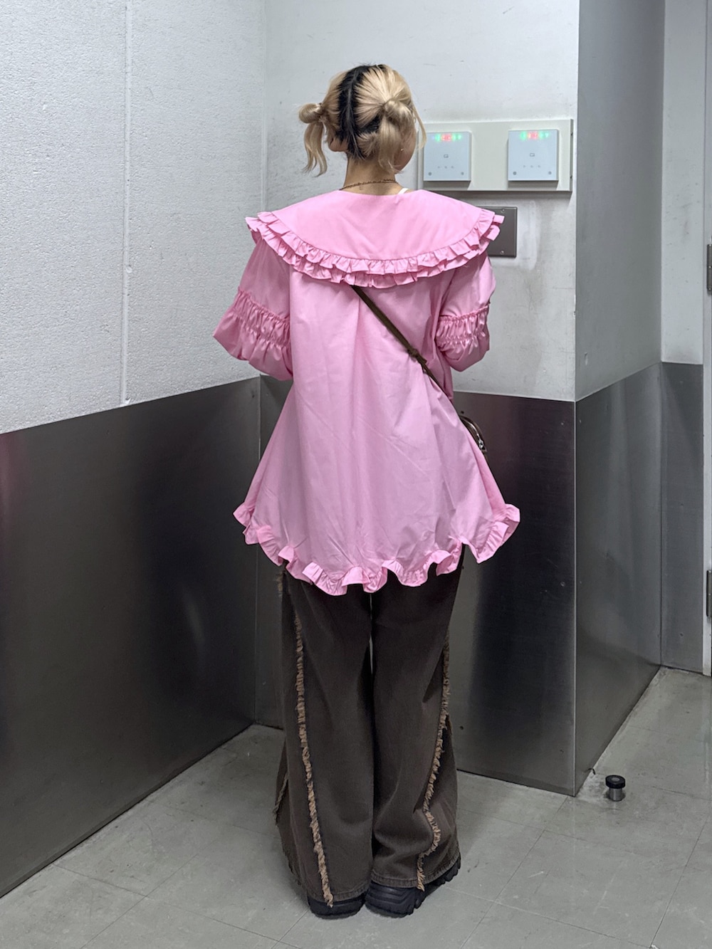 ホワイト系のワンピース、ブラウン系のデニムパンツを着用したレディースの春コーディネートの4枚目の写真