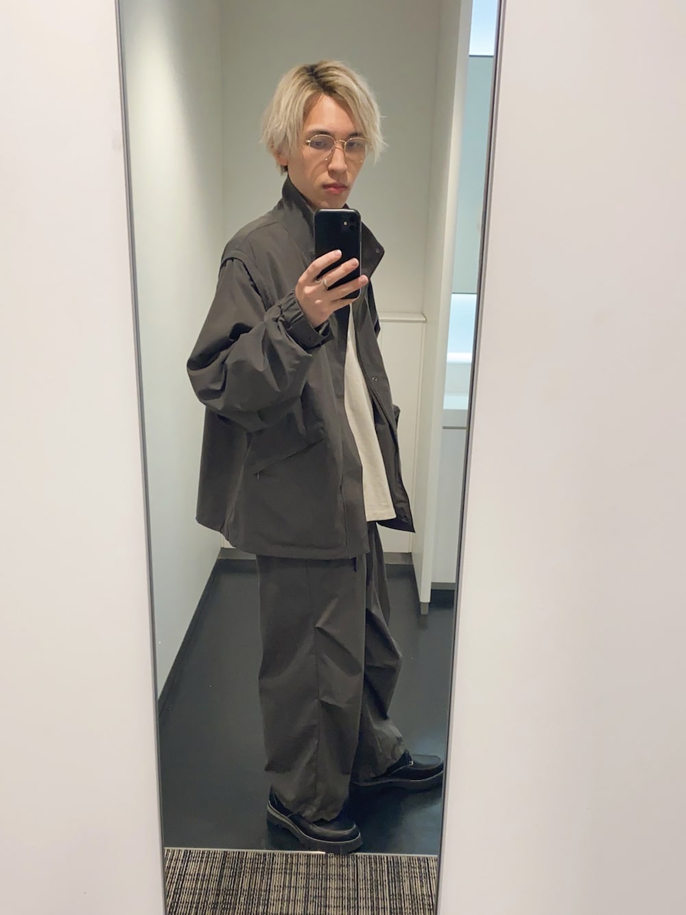 グレー系のその他パンツ、グレー系のナイロンジャケット、ブラック系のその他シューズを着用したメンズの春コーディネートの3枚目の写真