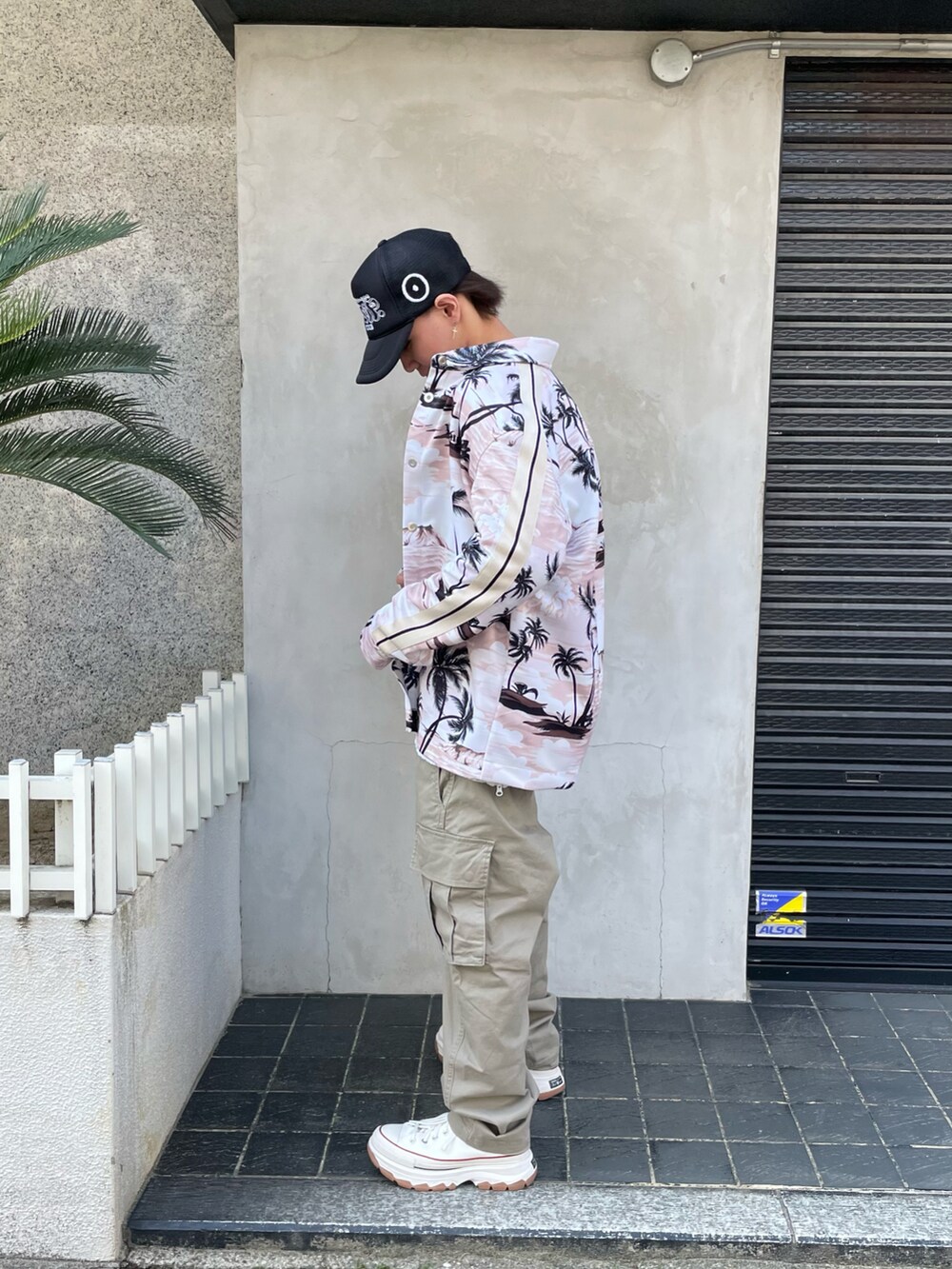 ホワイト系のニット/セーター、ベージュ系のパンツ、ホワイト系のニット/セーターを着用したメンズの春コーディネートの2枚目の写真