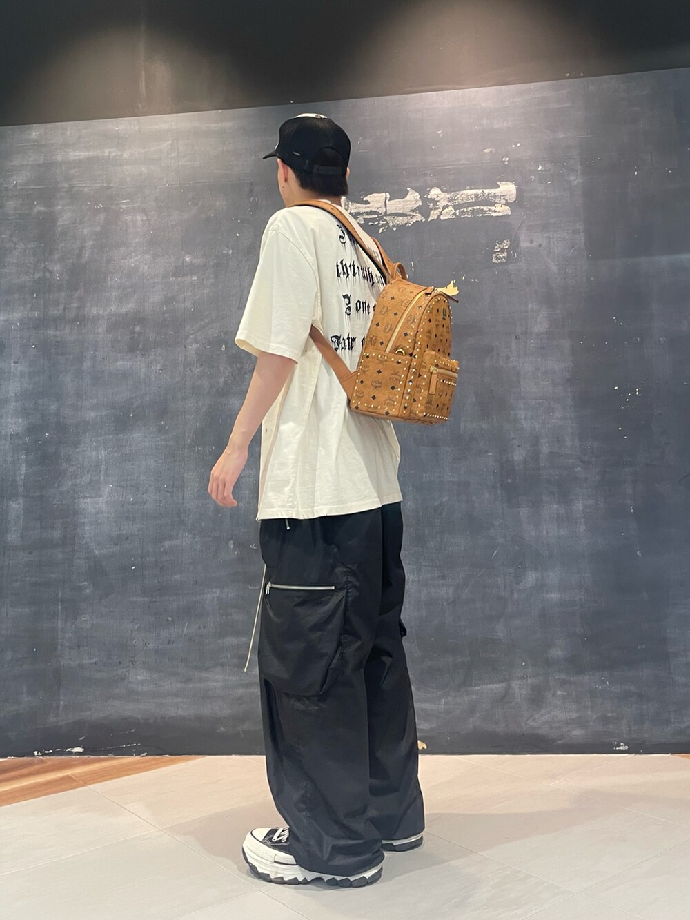 ブラック系のカーゴパンツ、ブラック系のカーゴパンツ、ホワイト系のTシャツ/カットソーを着用したメンズの夏コーディネートの2枚目の写真