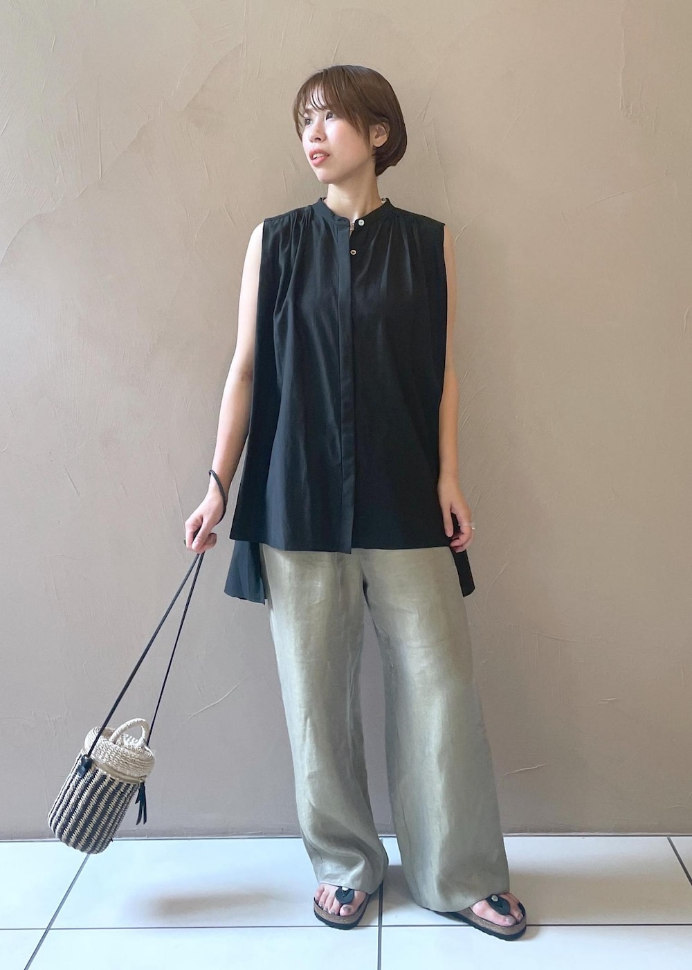 ホワイト系のショルダーバッグ、ブラック系のシャツ/ブラウス、グレー系のその他パンツを着用したレディースの夏コーディネートの2枚目の写真