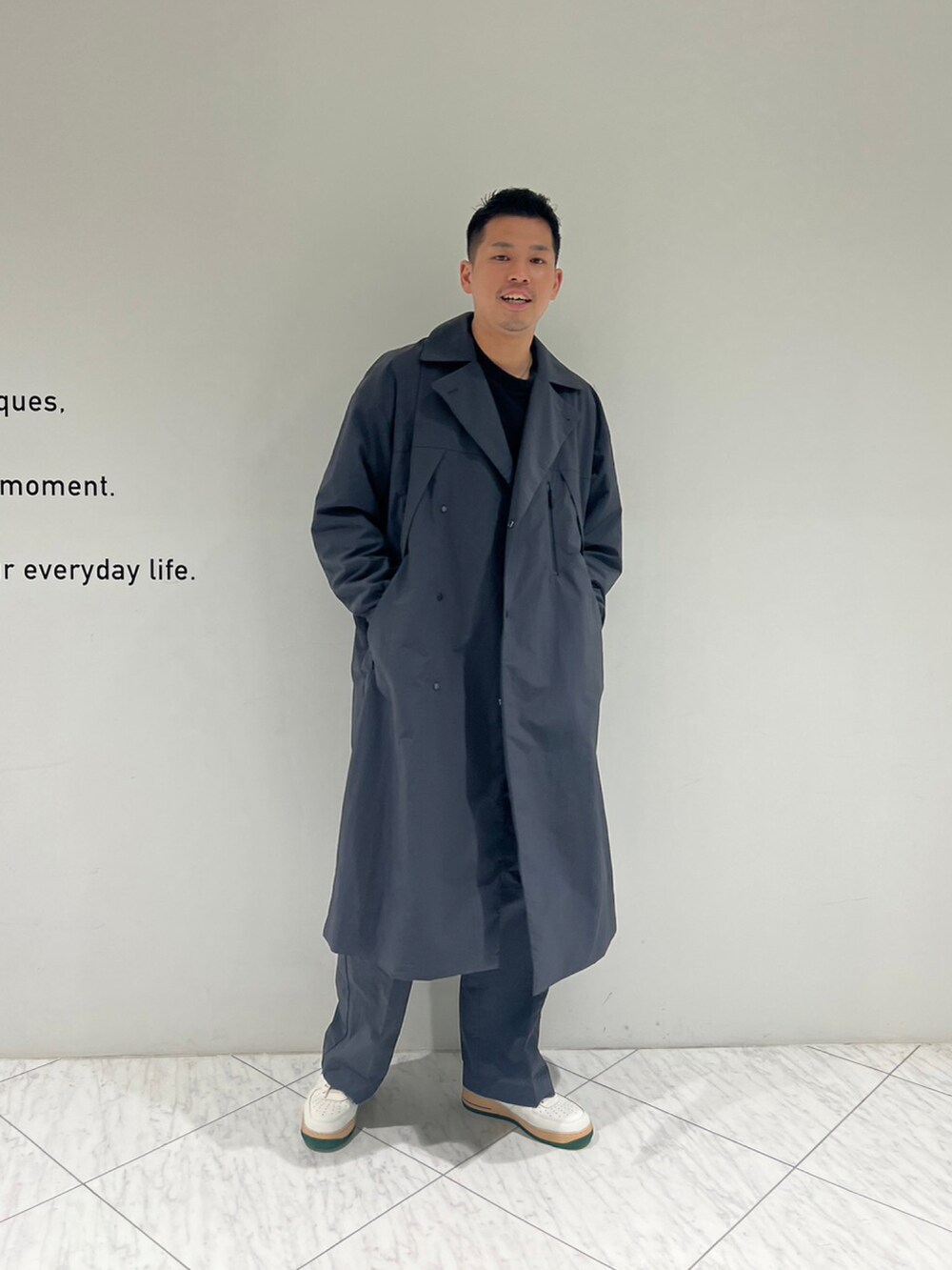 グレー系のチェスターコート、グレー系のスラックスを着用したメンズの秋コーディネートの5枚目の写真