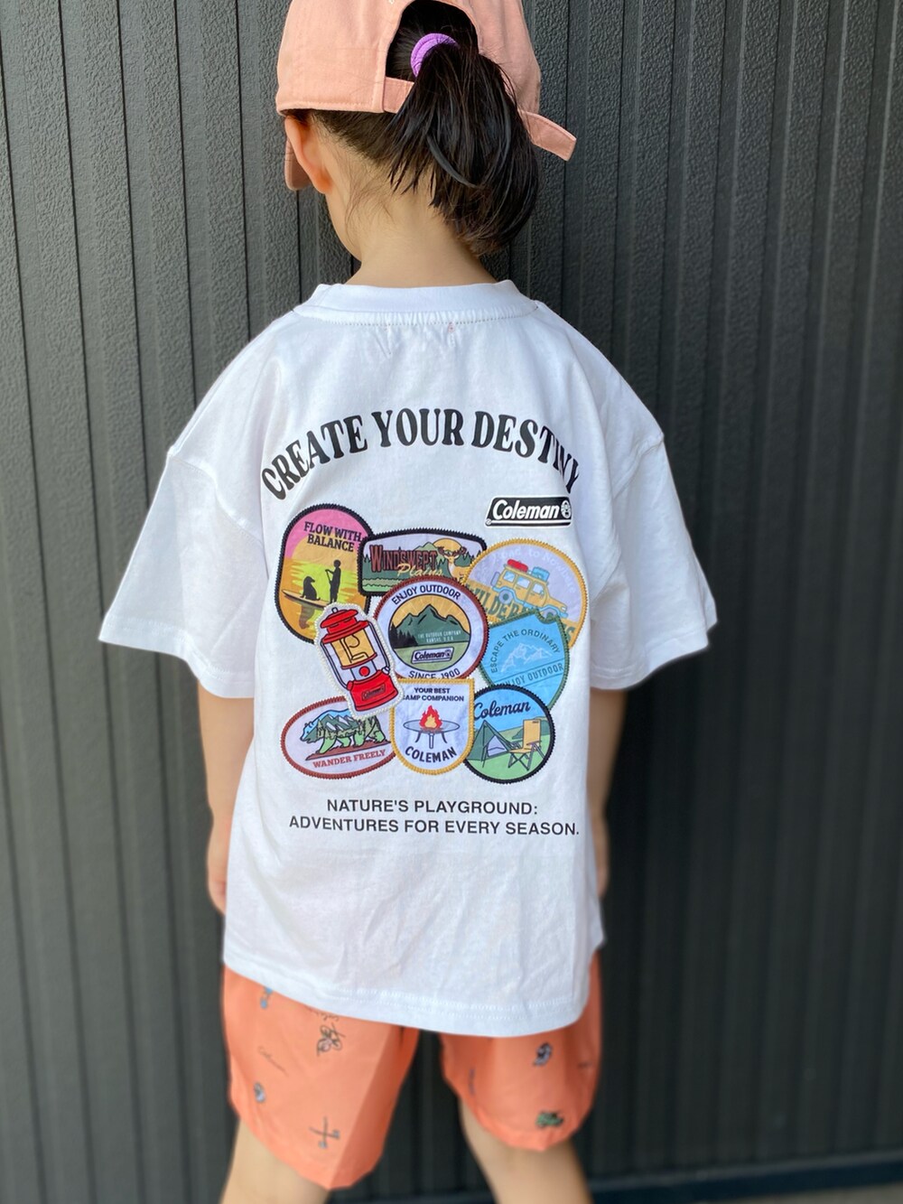 ホワイト系のTシャツ/カットソー、オレンジ系のパンツ、ベージュ系のサンダルを着用したキッズの夏コーディネートの3枚目の写真