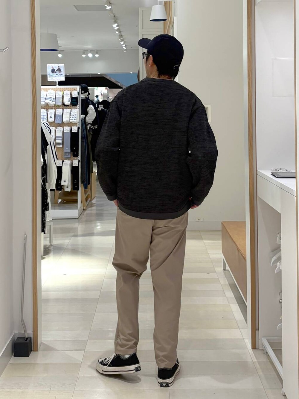 グレー系のニット/セーター、ベージュ系のその他パンツ、ブラック系のキャップを着用したメンズの秋コーディネートの3枚目の写真