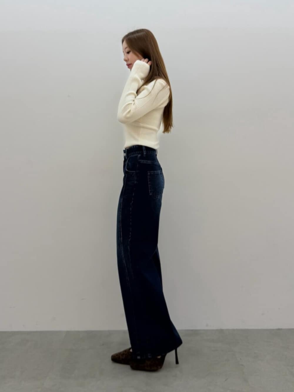 ブルー系のデニムパンツ、ホワイト系のニット/セーターを着用したレディースの夏コーディネートの2枚目の写真