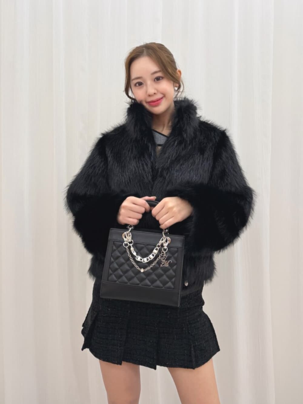 ブラック系のブーツ、ブラック系のブルゾン、ブラック系のハンドバッグを着用したレディースの冬コーディネートの5枚目の写真