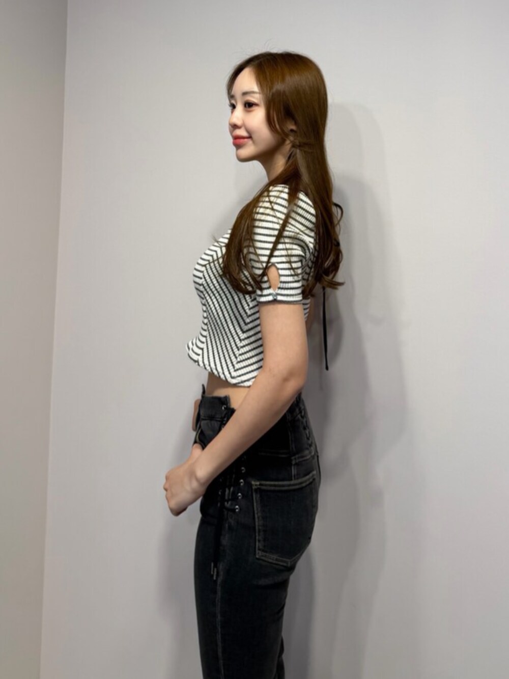 ブラック系のサンダル、その他のTシャツ/カットソー、ブラック系のデニムパンツを着用したレディースの春コーディネートの5枚目の写真