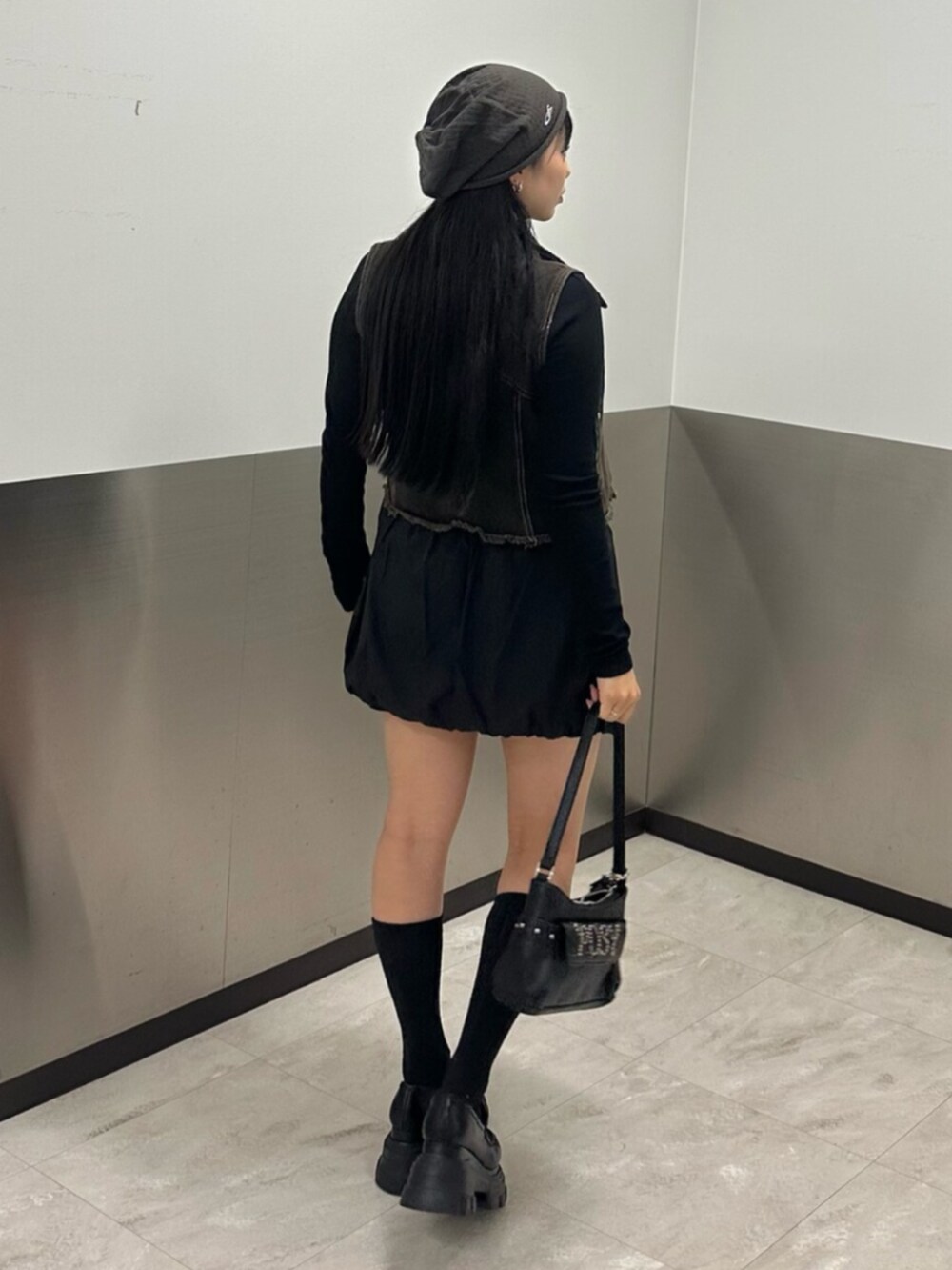 ブラック系のローファー、ブラック系のスカート、ブラック系のTシャツ/カットソーを着用したレディースの春コーディネートの4枚目の写真