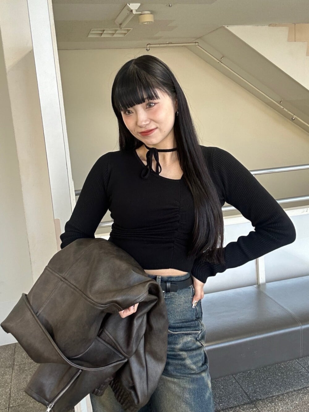 ブラック系のブーツ、ブルー系のデニムパンツ、ブラック系のニット/セーターを着用したレディースの冬コーディネートの7枚目の写真