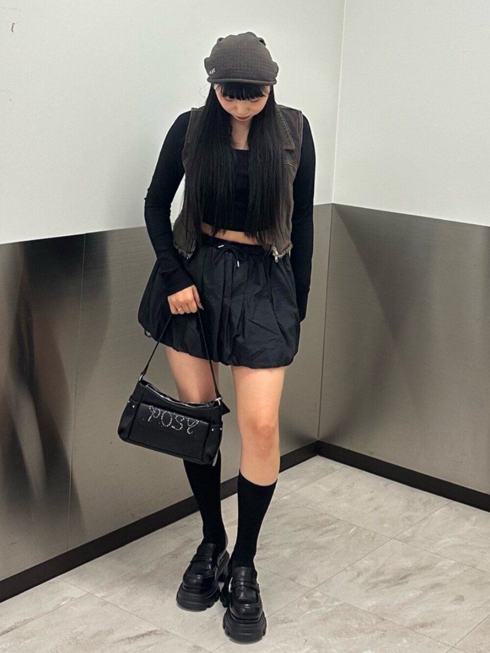 ブラック系のローファー、ブラック系のスカート、ブラック系のTシャツ/カットソーを着用したレディースの春コーディネートの2枚目の写真