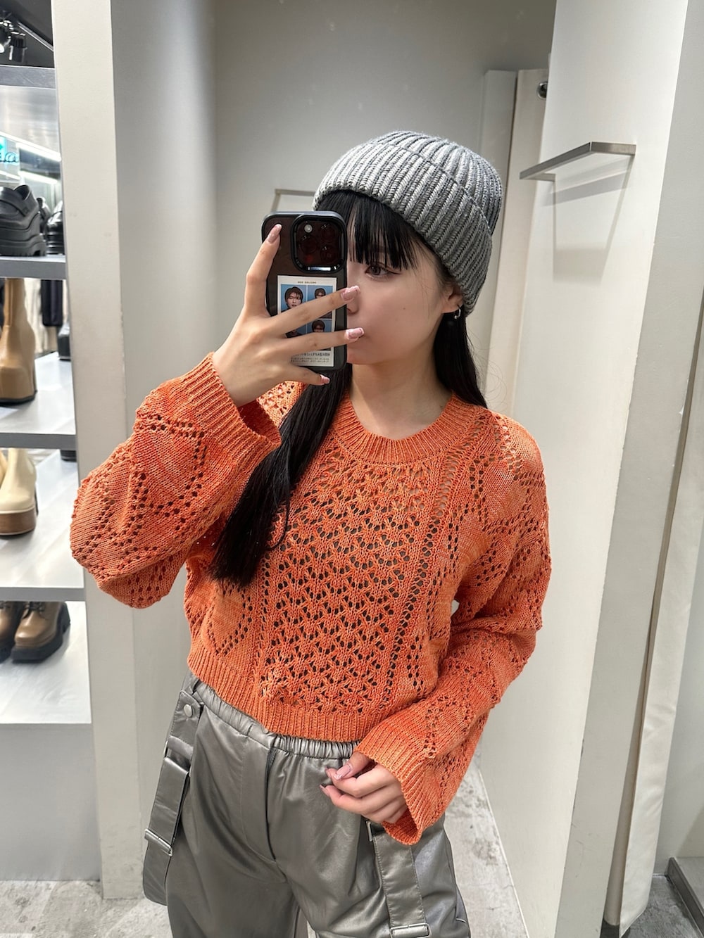 オレンジ系のニット/セーター、シルバー系のその他パンツ、グレー系のキャミソールを着用したレディースの冬コーディネートの5枚目の写真