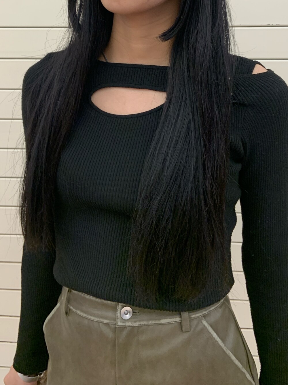 グリーン系のムートンコート、ブラック系のニット/セーター、グリーン系のスカートを着用したレディースの冬コーディネートの7枚目の写真