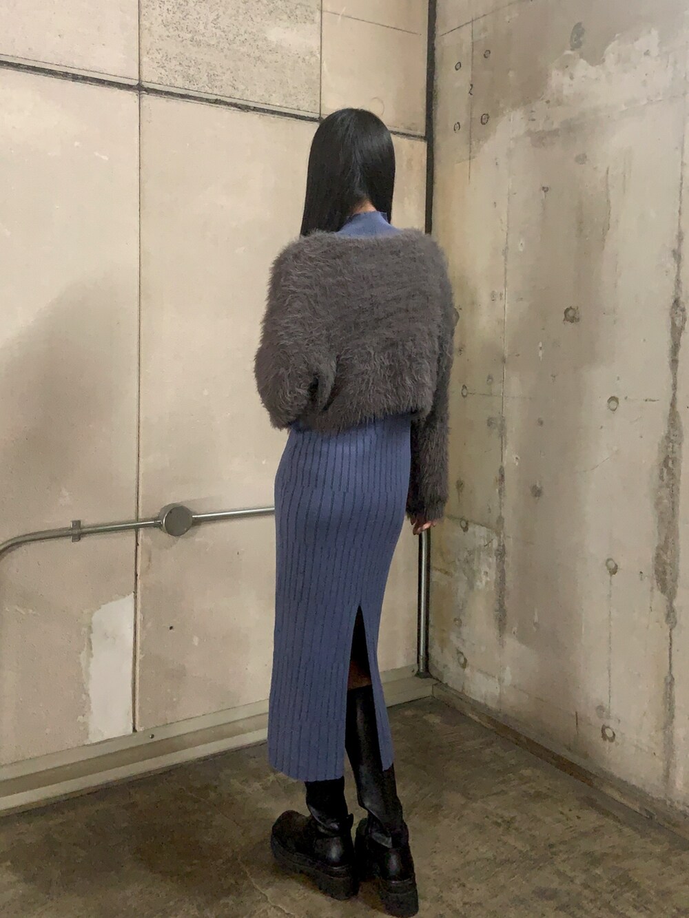 グレー系のニット/セーター、ブルー系のワンピース、ブラック系のブーツを着用したレディースの秋コーディネートの3枚目の写真