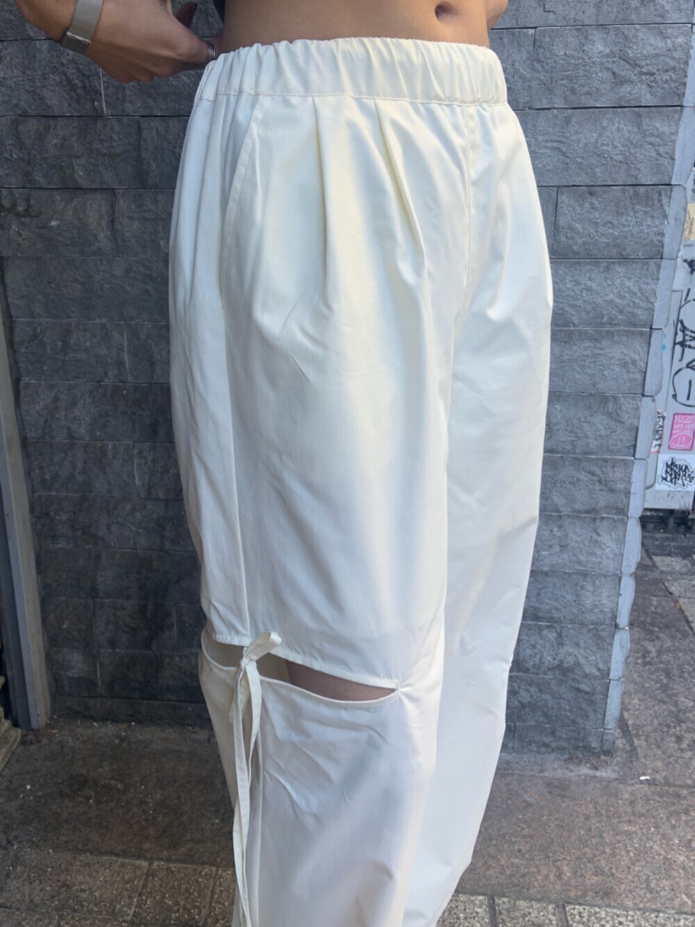 ブラック系のニット/セーター、ホワイト系のその他パンツ、ブラック系のブーツを着用したレディースの冬コーディネートの6枚目の写真