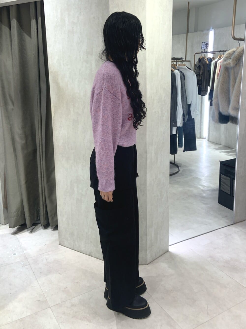 ブラック系のブーツ、ブラック系のカーゴパンツ、ピンク系のニット/セーターを着用したレディースの秋コーディネートの2枚目の写真