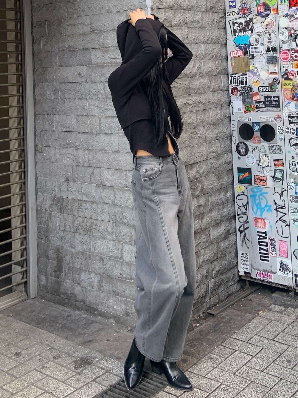 ブラック系のパーカー、ブラック系のデニムパンツ、ブラック系のブーツを着用したレディースの冬コーディネートの3枚目の写真