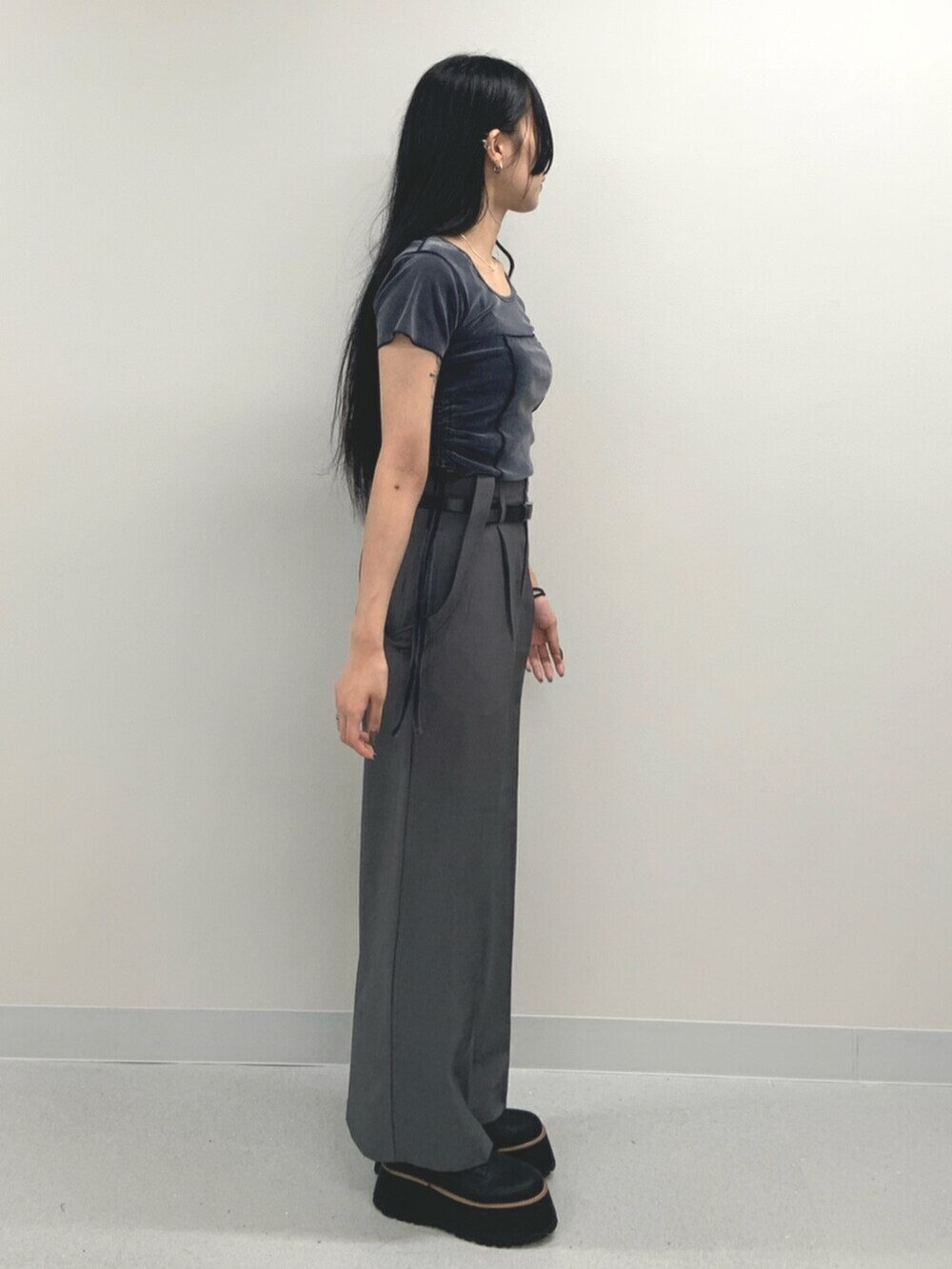 ブルー系のTシャツ/カットソー、ブラック系のブーツ、グレー系のスラックスを着用したレディースの夏コーディネートの3枚目の写真