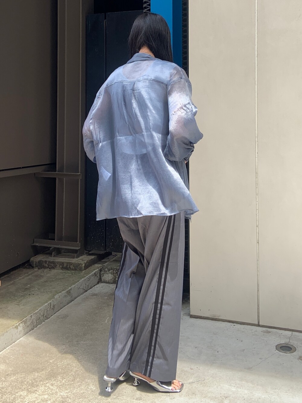 ブルー系のシャツ/ブラウス、ホワイト系のニット/セーター、グレー系のその他パンツを着用したレディースの春コーディネートの3枚目の写真