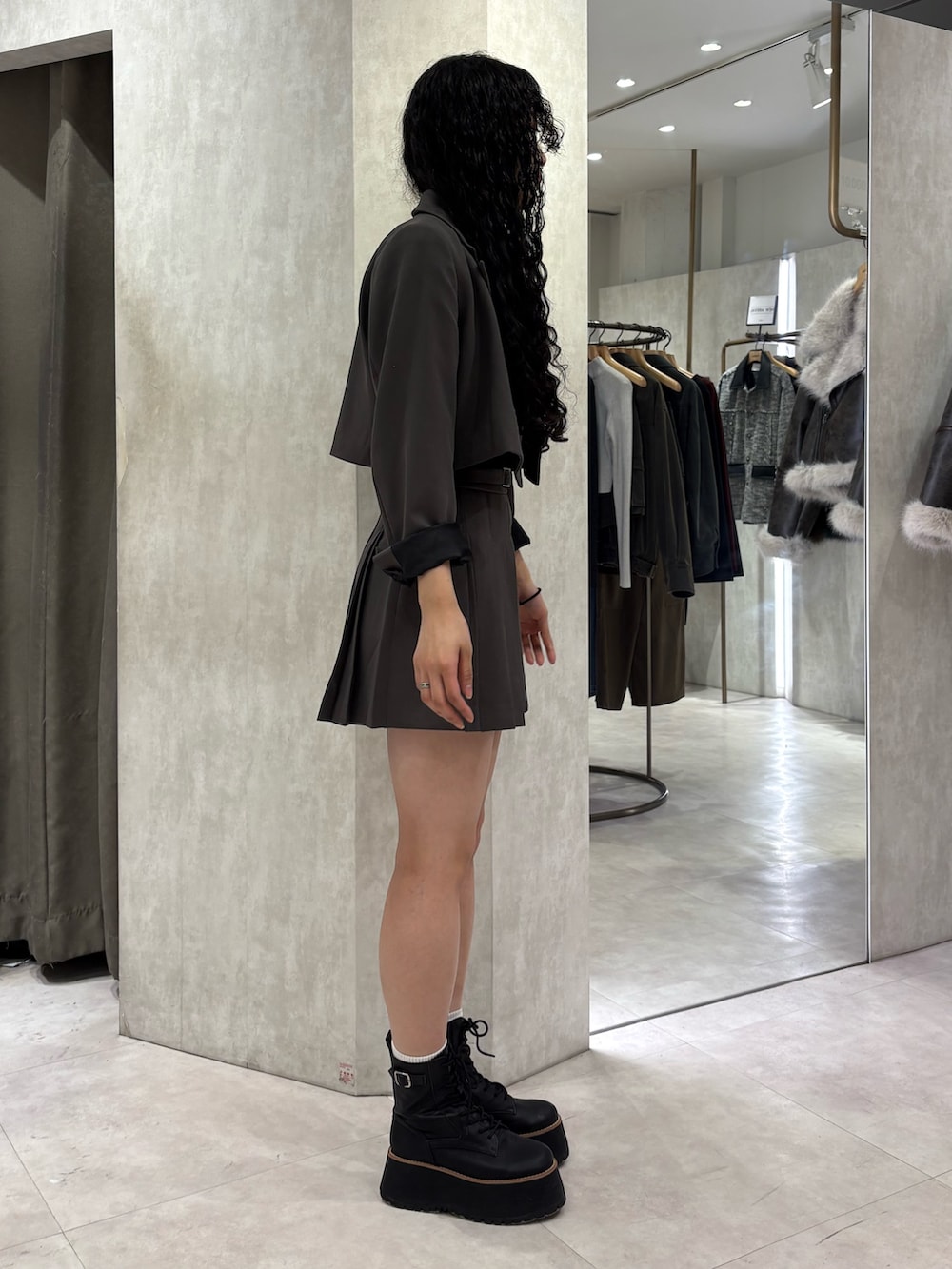 グレー系のテーラードジャケット、グレー系のスカートを着用したレディースの冬コーディネートの2枚目の写真