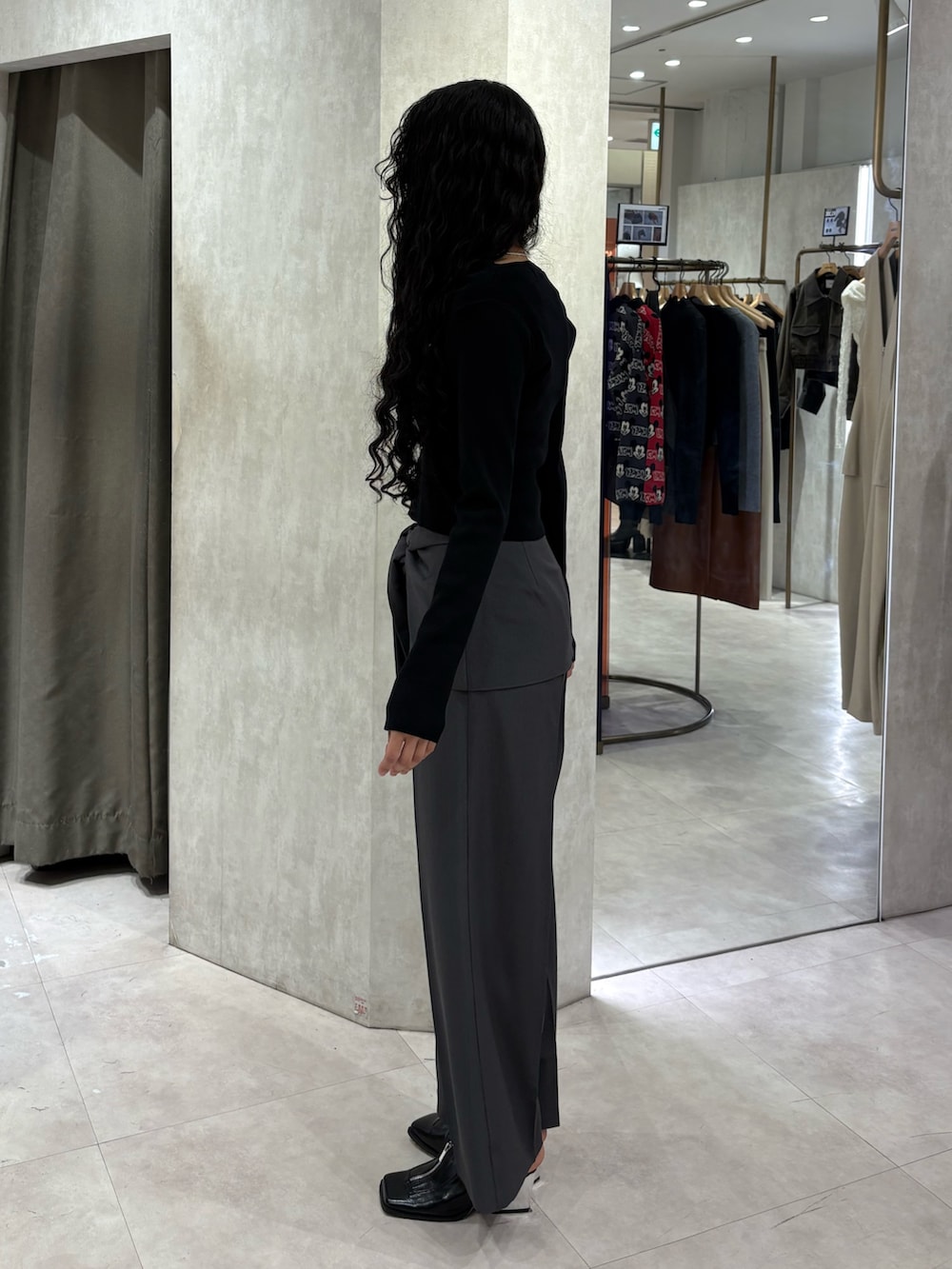 グレー系のその他パンツ、ブラック系のニット/セーターを着用したレディースの春コーディネートの2枚目の写真