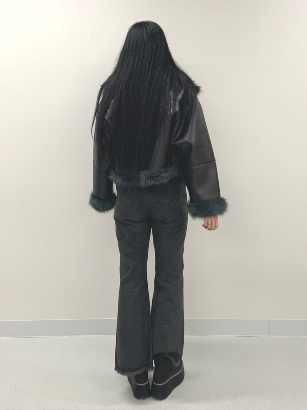 ブラック系のデニムパンツ、ブラック系のブーツ、ブラウン系のニット/セーターを着用したレディースの夏コーディネートの3枚目の写真