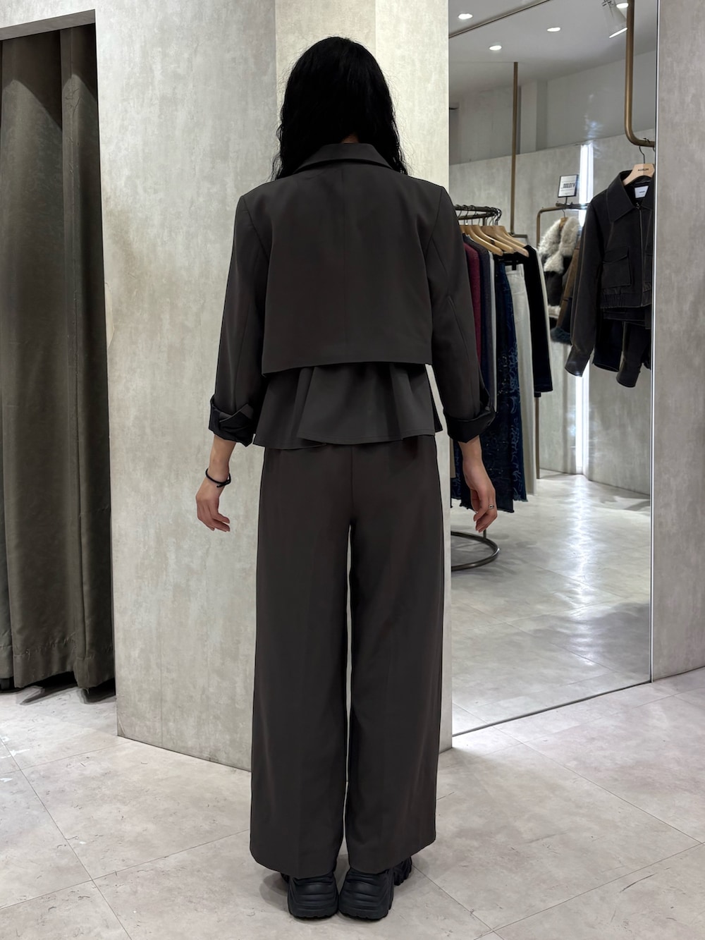 グレー系のテーラードジャケット、グレー系のその他トップス、グレー系のスラックスを着用したレディースの冬コーディネートの3枚目の写真