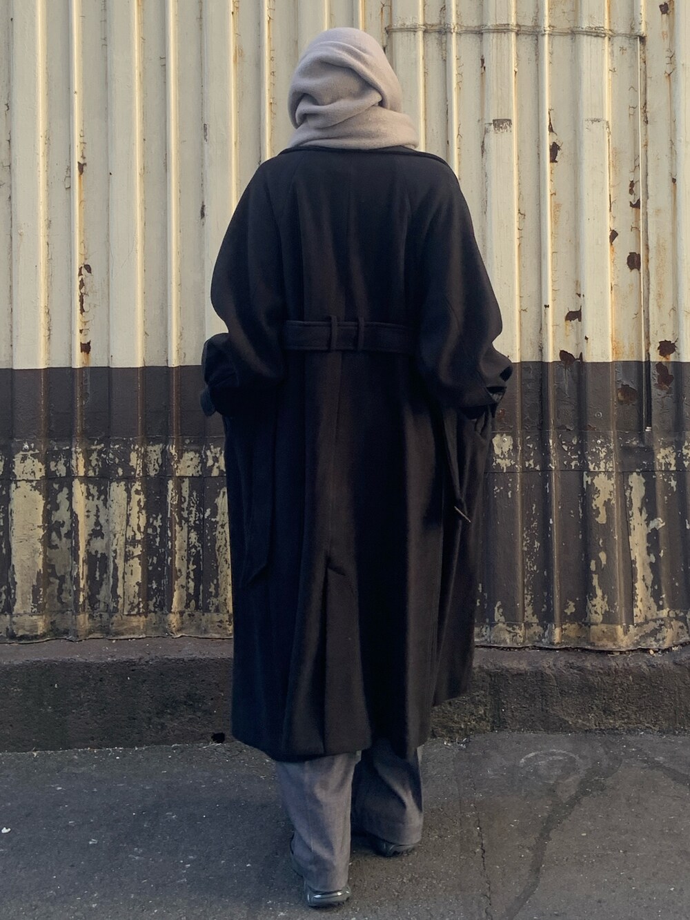 ブラック系のその他アウター、グレー系のその他パンツ、グレー系のマフラーを着用したレディースの冬コーディネートの4枚目の写真