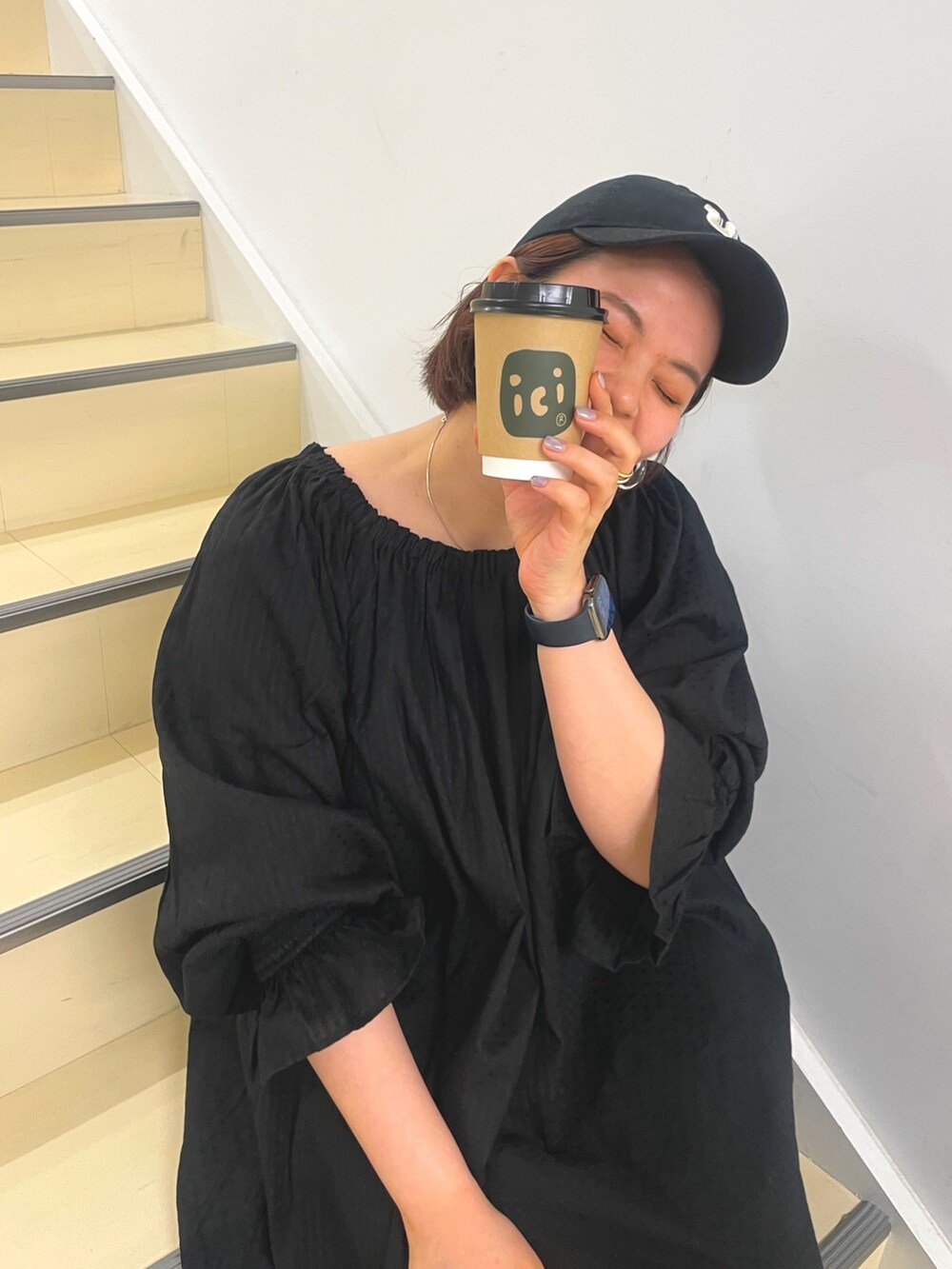 ブラック系のワンピース、ブラック系のキャップを着用したレディースの冬コーディネートの7枚目の写真