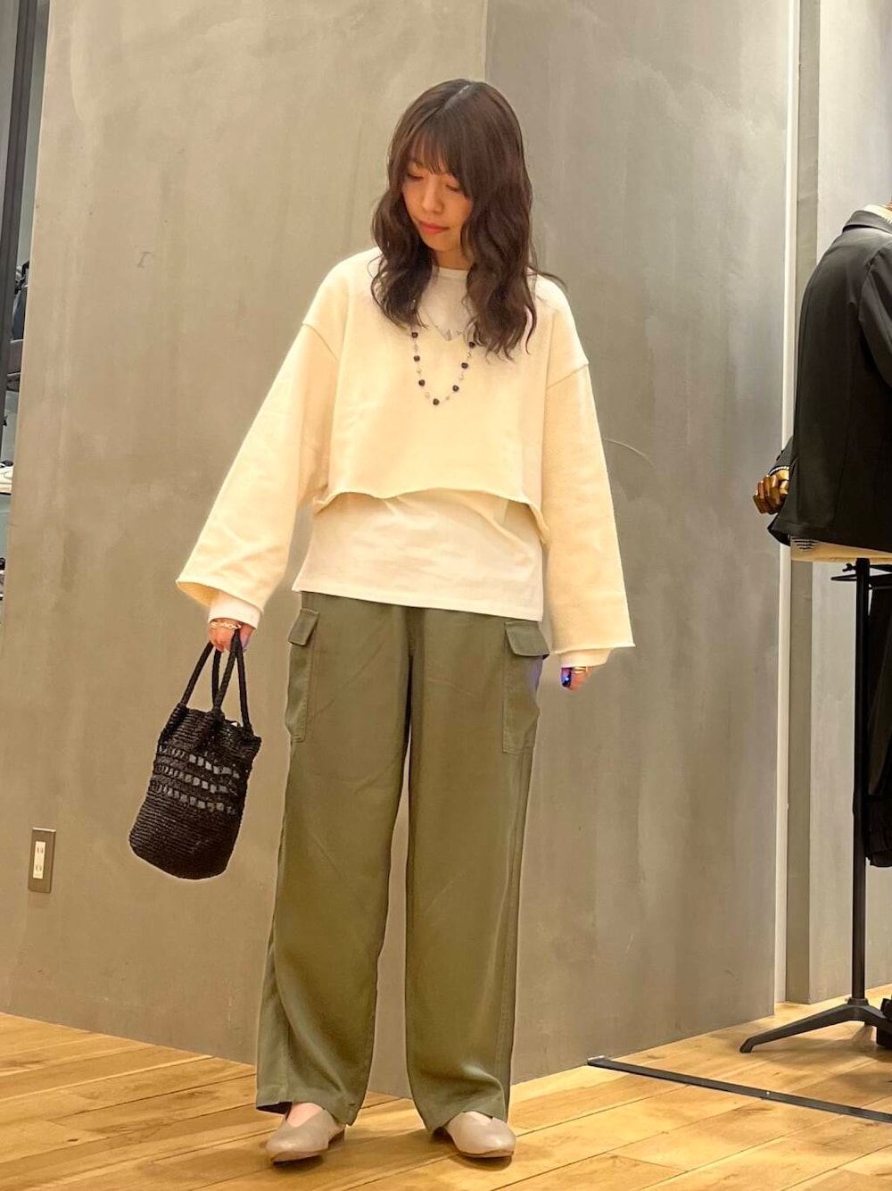 グレー系のパンプス、ホワイト系のTシャツ/カットソー、ブラック系のショルダーバッグを着用したレディースの冬コーディネートの3枚目の写真