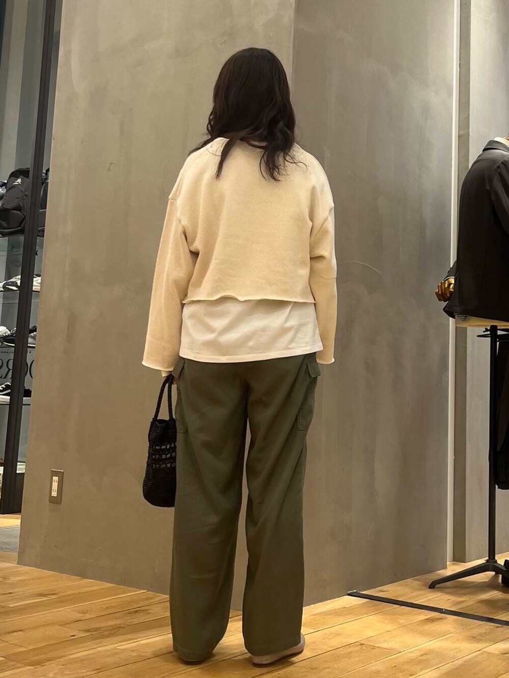 グレー系のパンプス、ホワイト系のTシャツ/カットソー、ブラック系のショルダーバッグを着用したレディースの冬コーディネートの5枚目の写真