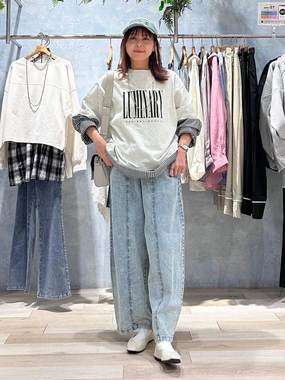 グレー系のショルダーバッグ、ホワイト系のパンプス、グレー系のTシャツ/カットソーを着用したレディースの春コーディネートの6枚目の写真