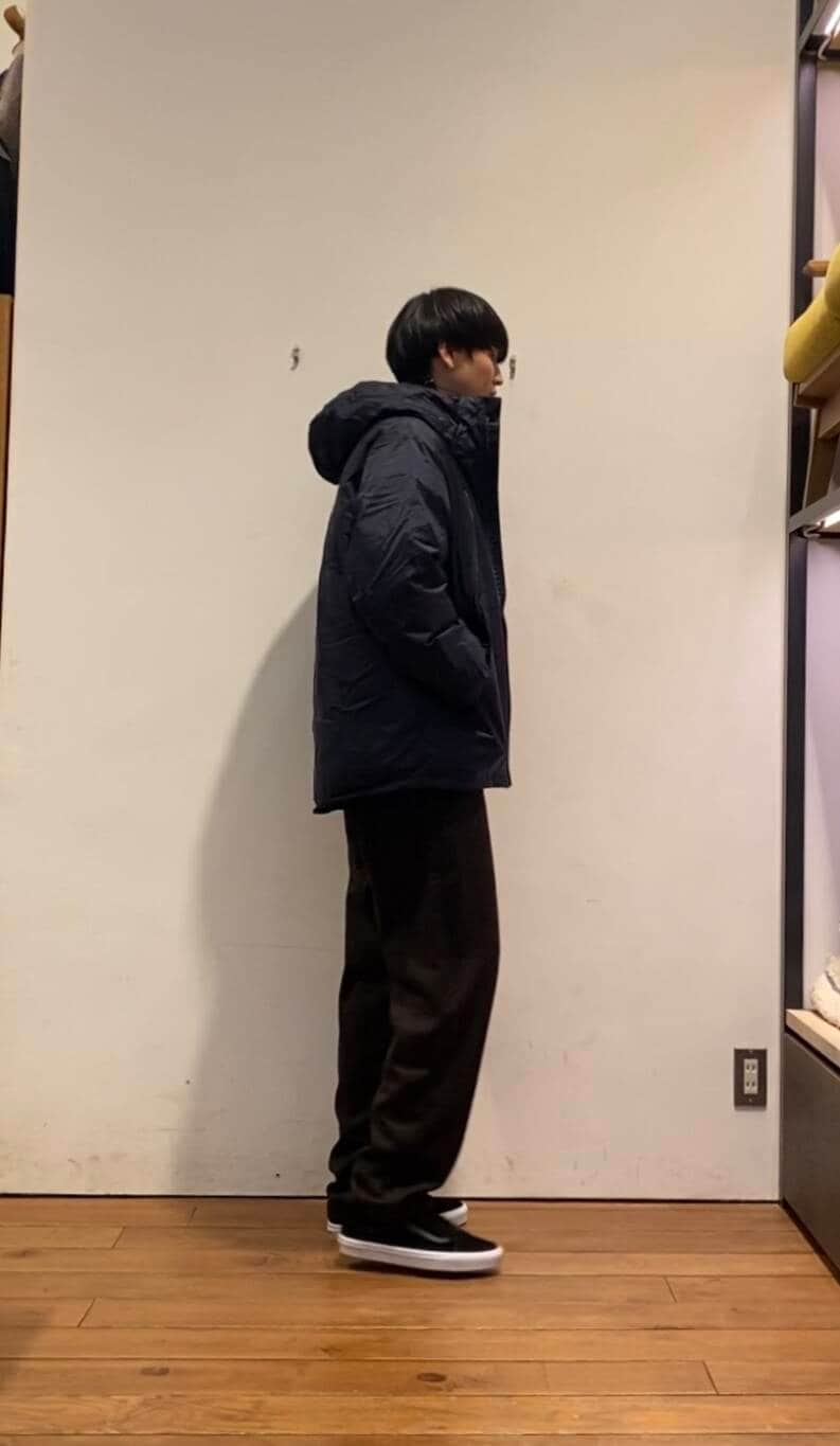 ブルー系のダウンジャケット/コート、ホワイト系のTシャツ/カットソー、ブラウン系のその他パンツを着用したメンズの冬コーディネートの3枚目の写真