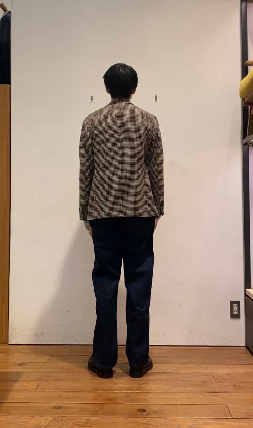 ブルー系のデニムパンツ、グレー系のニット/セーター、ブラウン系のその他アウターを着用したメンズの冬コーディネートの4枚目の写真