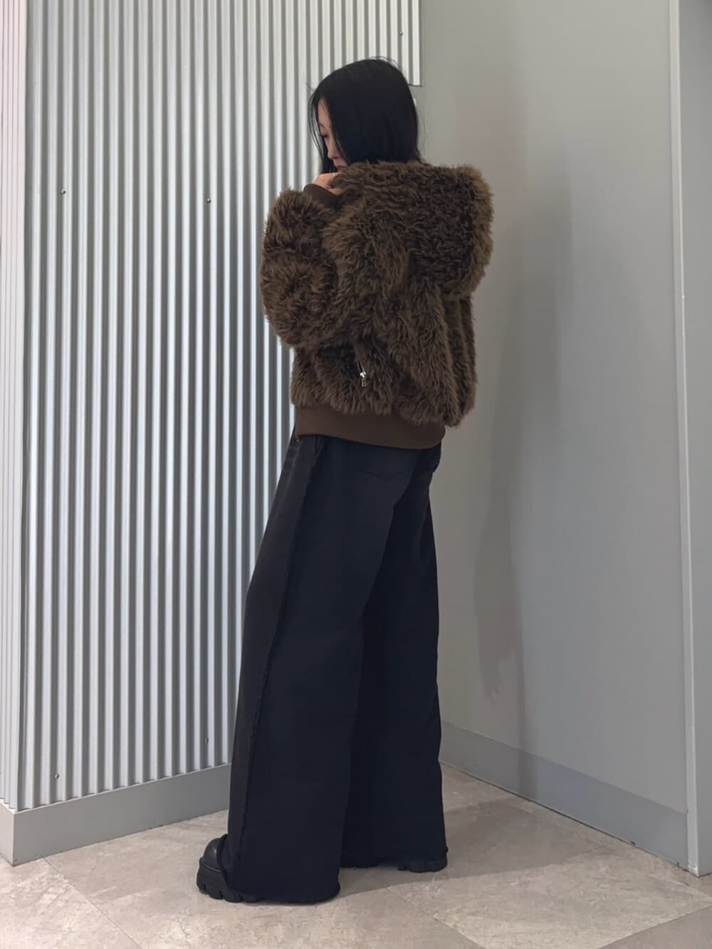 ブラウン系のブルゾン、その他のニット/セーター、ブラック系のスウェットパンツを着用したレディースの冬コーディネートの5枚目の写真