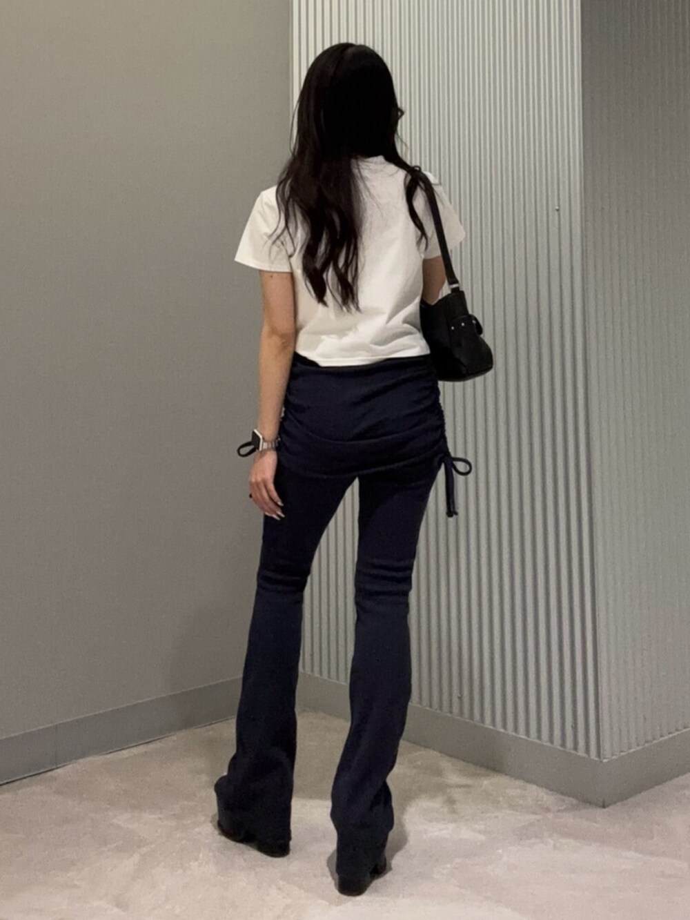 ブルー系のその他パンツ、ホワイト系のTシャツ/カットソー、ブラック系のサンダルを着用したレディースの春コーディネートの4枚目の写真