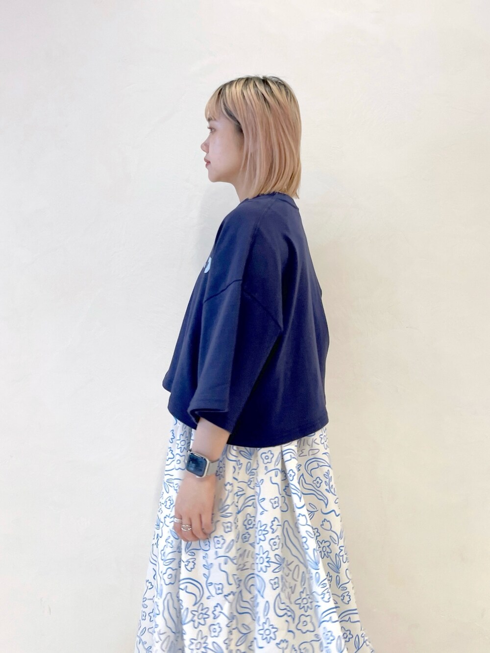 ホワイト系のワンピース、ブルー系のTシャツ/カットソー、ブラック系のブーツを着用したレディースの夏コーディネートの6枚目の写真