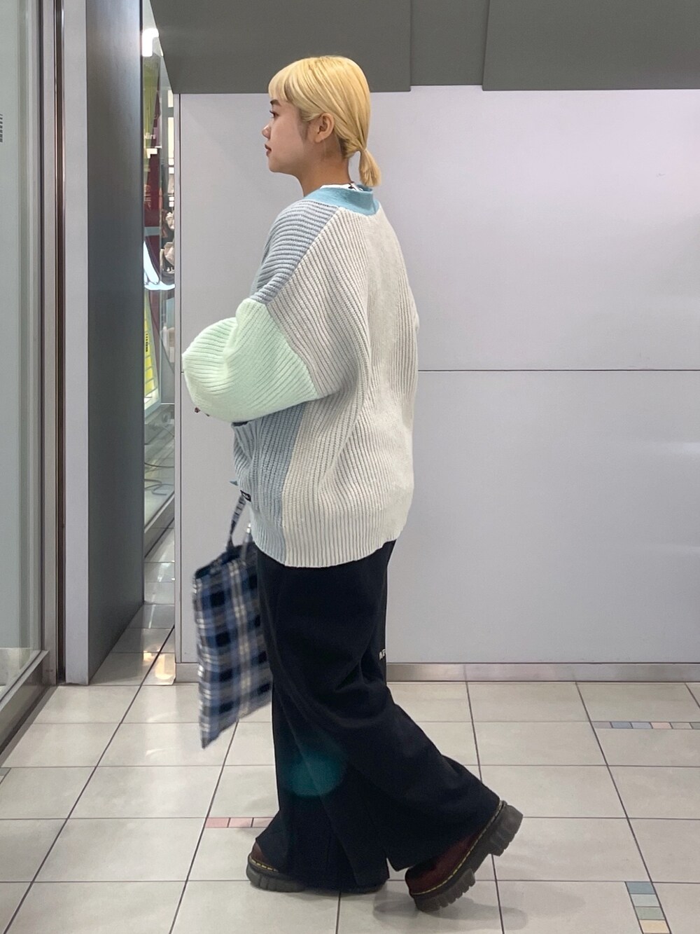 ブラック系のスウェットパンツ、ブルー系のトートバッグ、グリーン系のカーディガン/ボレロを着用したレディースの冬コーディネートの5枚目の写真