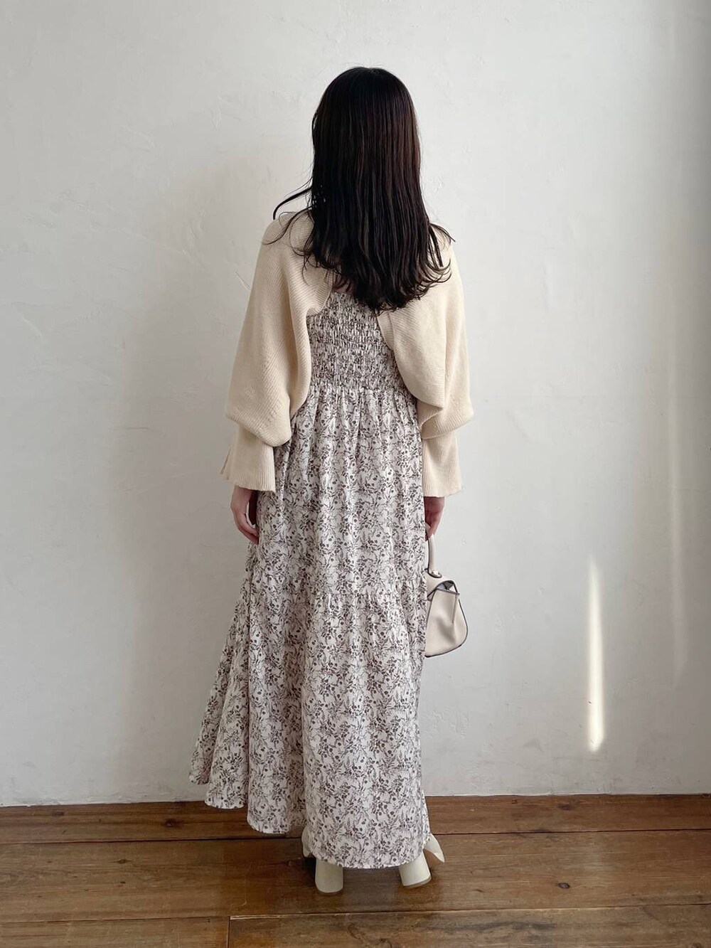 ホワイト系のハンドバッグ、ホワイト系のブーツ、ホワイト系のワンピースを着用したレディースの秋コーディネートの2枚目の写真