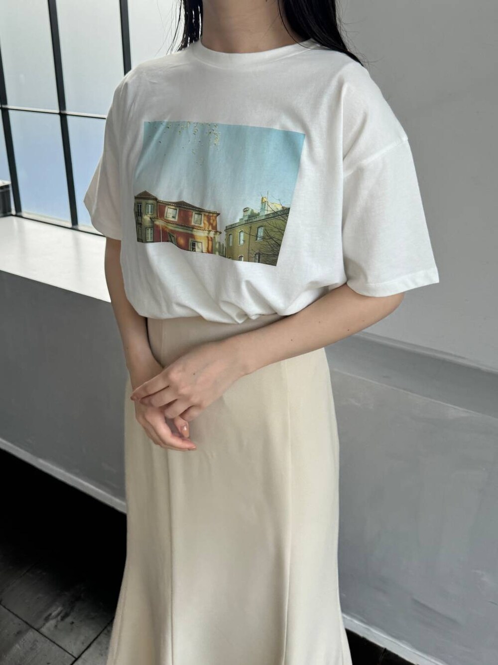 ホワイト系のTシャツ/カットソー、ホワイト系のサンダル、ベージュ系のスカートを着用したレディースの春コーディネートの3枚目の写真