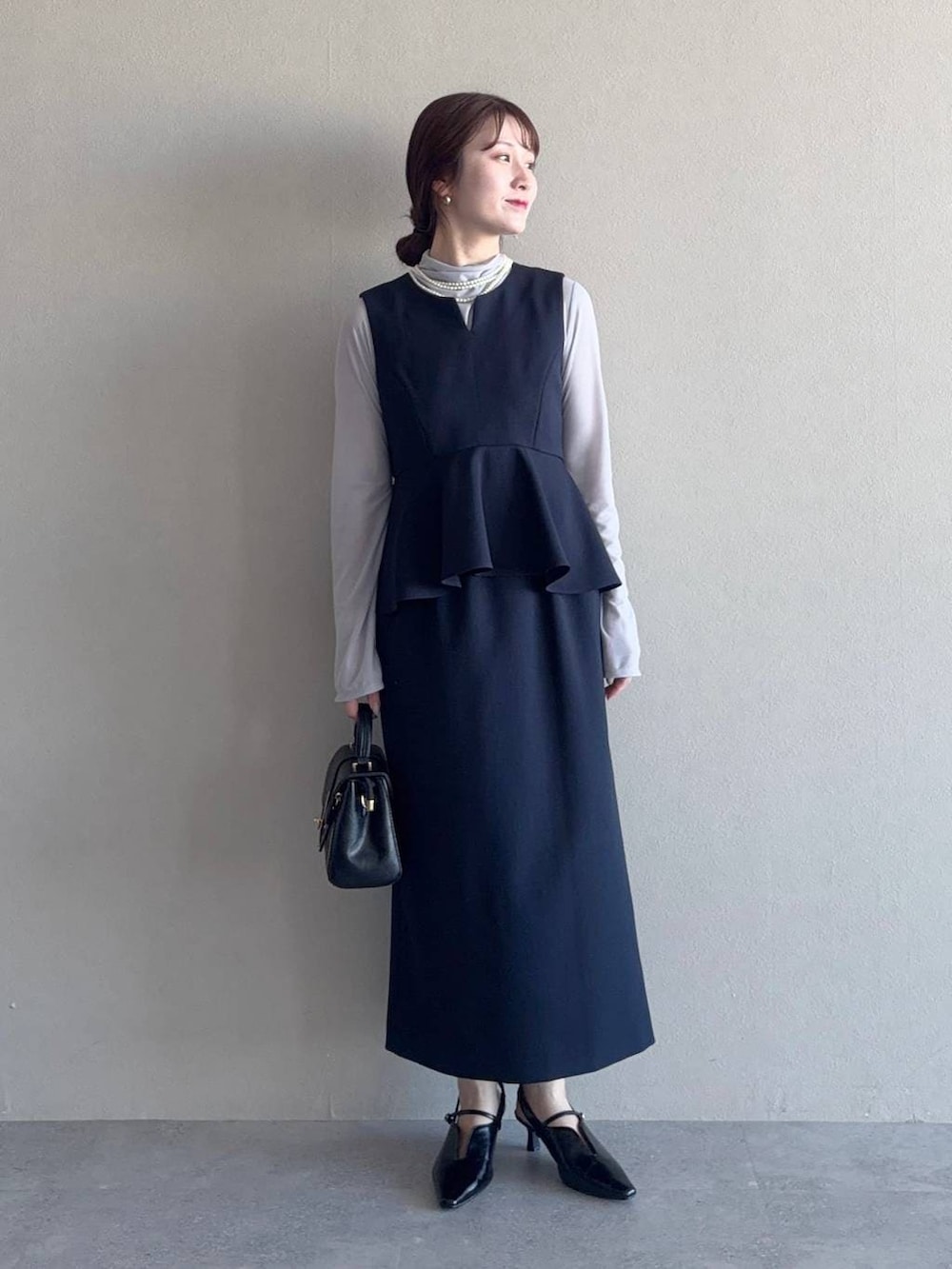 グレー系のTシャツ/カットソー、ブラック系のショルダーバッグ、ブルー系のテーラードジャケットを着用したレディースの冬コーディネートの3枚目の写真